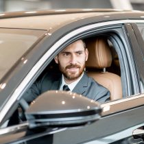 businessman-in-the-luxury-car-2023-11-27-05-35-35-utc-scaled